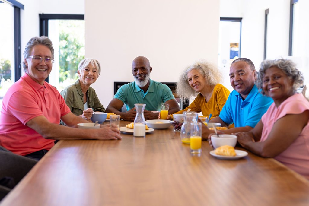 A group of aged people sitting on table with proper diet plan.